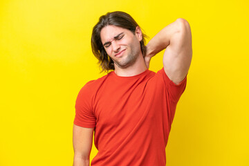 Caucasian handsome man isolated on yellow background with neckache