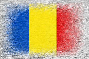 Flag of Romania. Flag is painted on a cement wall. Cement background. Plastered surface. Copy space. Textured background