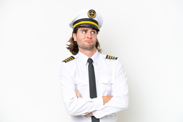 handsome Airplane pilot isolated on white background making doubts gesture while lifting the shoulders