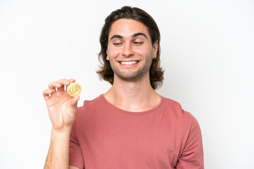 Young handsome man holding a Bitcoin isolated on white background with happy expression