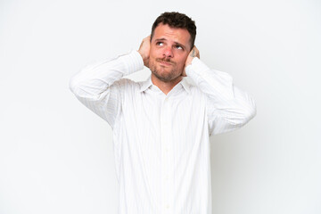 Fototapeta premium Young caucasian handsome man isolated on white background frustrated and covering ears