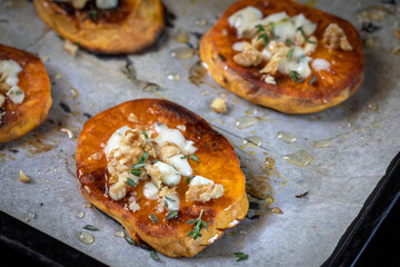 Baked sweet potato with blue cheese, sliced and sprinkled with honey.