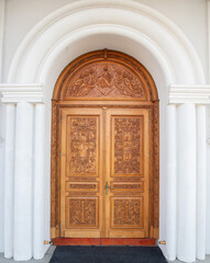 A carved wooden door at the Orthodox church in Reghin city - Romania
It is handmade with floral and religious motifs