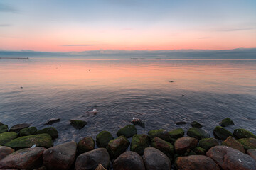 the setting sun in Gdynia behind the sea horizon