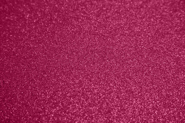 Viva magenta shiny blurred background for holiday design. Christmas abstract sparkles, selective focus