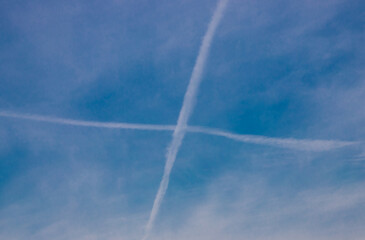 A cross in the sky made by the tracks of some planes