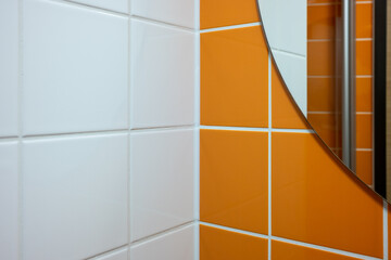 bathroom corner with orange and white tiles