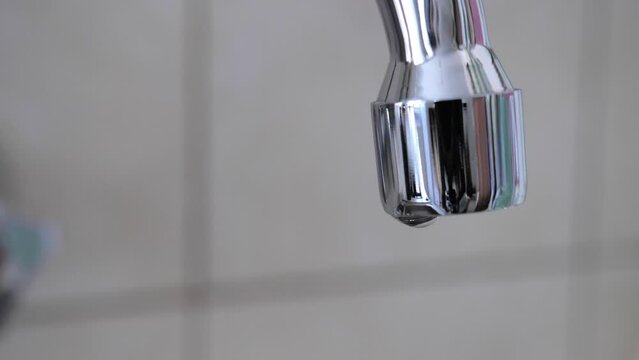 Dripping faucet, waste of water. Slow motion
