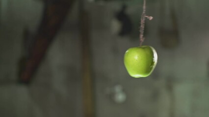 an arrow pierces a green apple. High quality Full HD video recording. slow motion video - Powered by Adobe