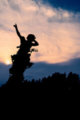 The silhouette of a motorcyclist at sunset. Moto rider making a stunt on his motorbike.