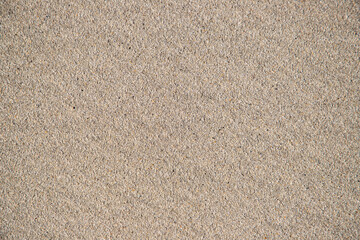 Fototapeta na wymiar A top view of a layer of sand without bumps