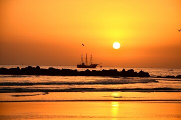 ship in sunset at agadir beach, morocco