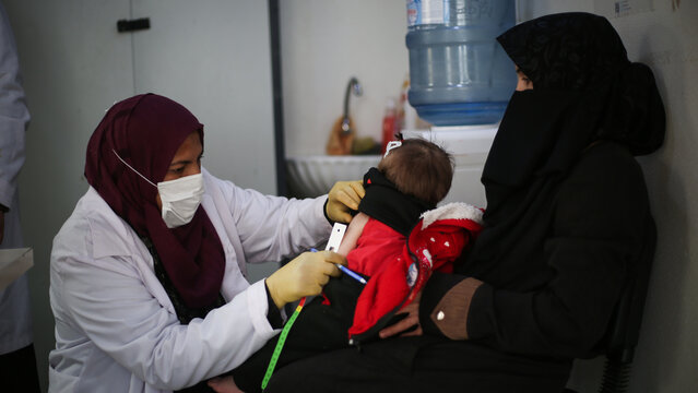 Doctor examines child malnutrition. Measuring malnutrition using strap MUAC mid-upper-arm-circumference.	
