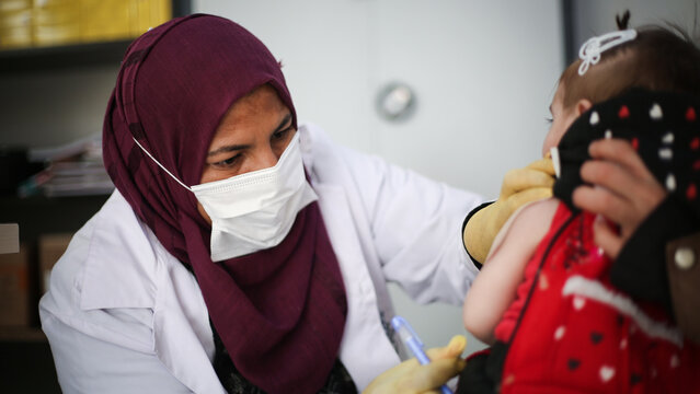 Doctor examines child malnutrition. Measuring malnutrition using strap MUAC mid-upper-arm-circumference.	
