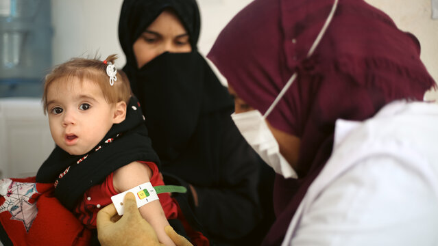 Doctor examines child malnutrition. Measuring malnutrition using strap MUAC mid-upper-arm-circumference.	
