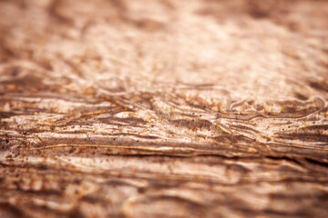 Extreme closeup of crumpled brass foil texture