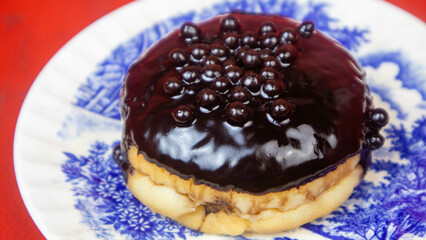 Chocolate donuts on a plate on a red background
