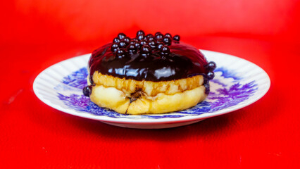 Chocolate donuts on a plate on a red background