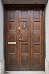 Image of Wooden vintage entrance door with handle knocker and handle