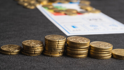 euro moyers on a black background in denominations of 20 and 50 cents. concept of economic downturn in europe