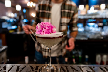 man bartender making cocktail in bar