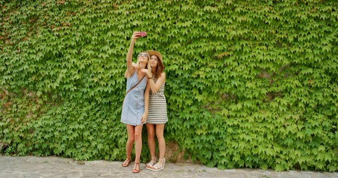 Girl friends, travel and phone selfie of women with nature leaf background for holiday photo together. Vacation picture, happiness and ivy park in Italy with people holding a mobile in summer happy