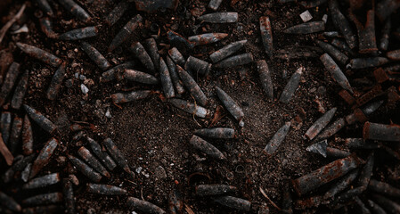Burnt ammunition, bullets and casings after the fire. Burned arsenal of weapons, fire in the...