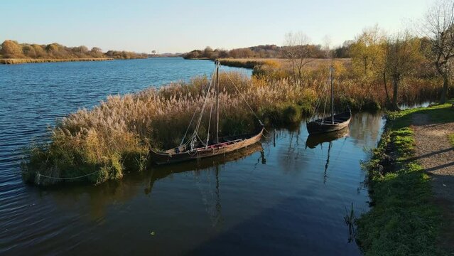 Aerial shot by the lake, with ancient boats
