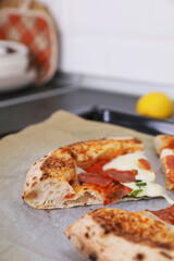 Neapolitan pizza with sausage and jalapeno in the kitchen at home