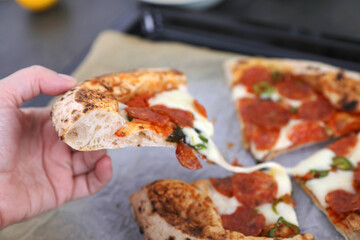 Neapolitan pizza with sausage and jalapeno in the kitchen at home