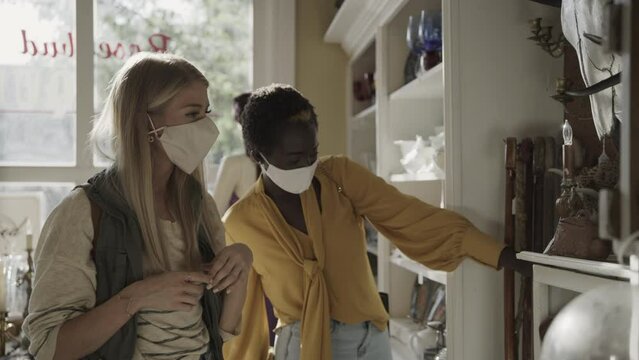 Women shopping in retail store wearing protective masks / Pleasant Grove, Utah, United States