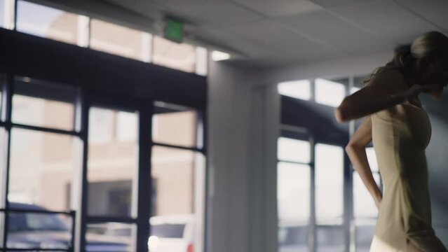 Low angle view of woman practicing contemporary dancing in dance studio / Lehi, Utah, United States
