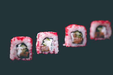 California sushi rolls on a dark background. Selective focus, isolated on black background.