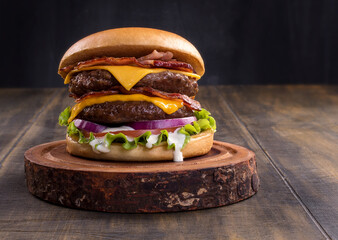 Fresh tasty burger on wood table. cheese beef burger consists of bun bread, lettuce, tomato, onion,...