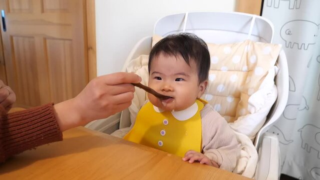 Japanese 0-year-old baby is eating baby food