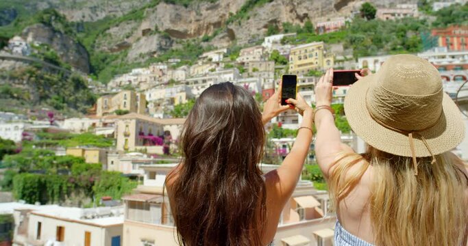 Travel, women and photography Italy with phone for social media, vacation memory or freedom on summer holiday, sightseeing and city. Friends take mobile pictures of buildings, landscape and adventure