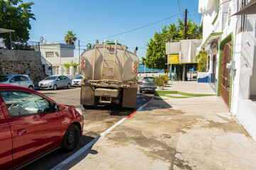 A drinking water delivery truck seen from the rear on a street in La Paz, Baja de California Sur,...