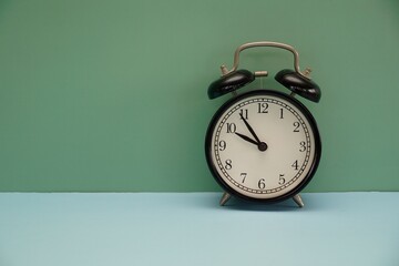 alarm clock against gren background - 551082336