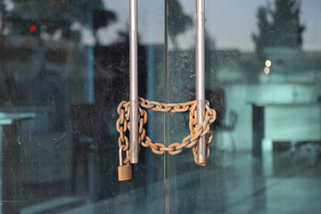 There is a lock on the office door. Rusty chain on glass door and lock on it, bankrupt or closed...