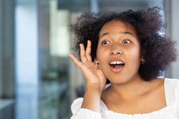Fototapeta premium Surprised African woman hearing or listening to bad news