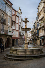 Fototapeta premium Praza do Ferro (Plaza del Hierro). Antique fountain the old town centre of Ourense, historic buildings and fountan on the stone streets. Galicia, Spain.