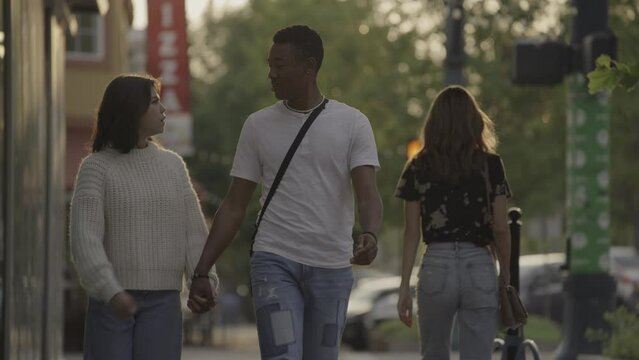 Woman arguing with boyfriend admiring passing woman on sidewalk / Provo, Utah, United States