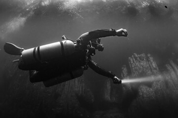 cave diver instructor leading a group of divers in a mexican cenote underwater