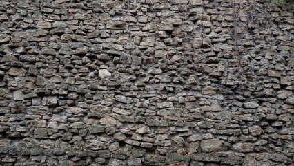 old masonry wall carelessly built and partially broken