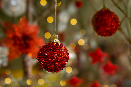 Soft focus red Christmas ornaments and gold light bokeh