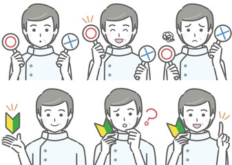 〇✕マークや初心者マークを持つ中年男性看護師