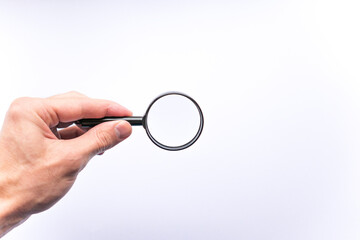 Magnifying glass in hand on white background, concept of search