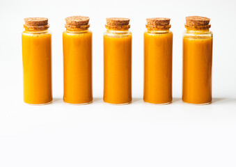Homemade Immune Boosting Turmeric Ginger Citrus Shots. Anti-Inflammatory Vitamin Healthy Drink. White background, top view, free space for text. Natural Immunity System Booster