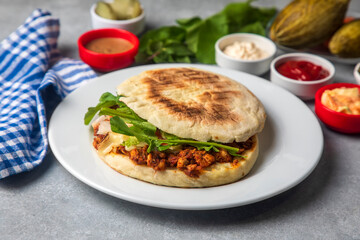 Fried chicken with sauce in pita bread served with salad dressings. Turkish name; tavuk kokorec or tavuk doner or tavuk durum)