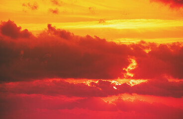Dramatic cloudy sky at sunset. Orange red gradient color. Sky texture, abstract nature background